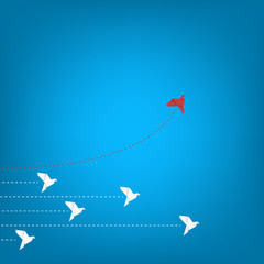 Think differently concept. Be different. Red bird changing direction. New idea, change, trend, courage, creative solution, innovation and unique way concept	