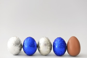 Sweet chocolate eggs on light background