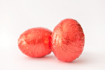 Sweet chocolate eggs on white background