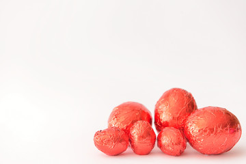 Sweet chocolate eggs on white background