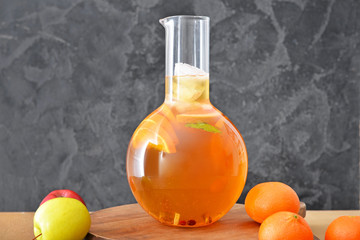 Jug of tasty cold tea on table