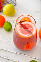 Jug of tasty cold tea on white background