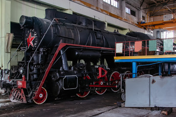 Old Soviet steam locomotive at the train depot