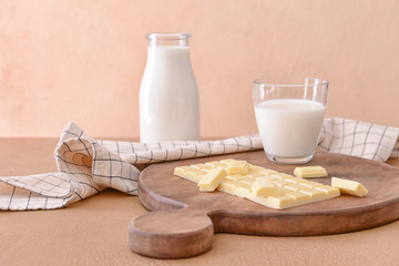 Sweet white chocolate and milk on table