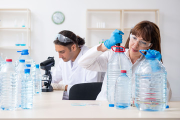 Two chemists working in the lab