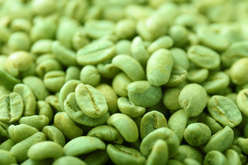 Green coffee beans as background