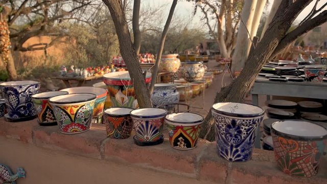 Colorful Handmade Ceramic Pottery, For Sale And Display Outside a Shop In Tubac, Arizona. -panning shot