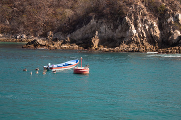 Fototapeta premium boat in turquoice ocean water in the beach