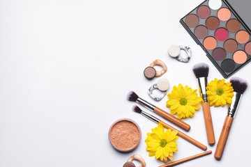 Makeup cosmetics with accessories on white background