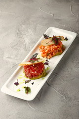 salmon and tuna tartar on table. Japanese light meal. microgreen healthy food