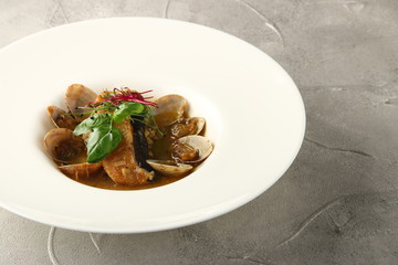 mussels and salmon with herbs in white plate