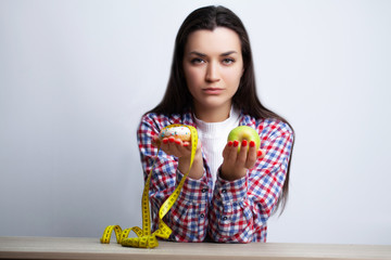 Beautiful woman who makes a choice between useful and harmful food