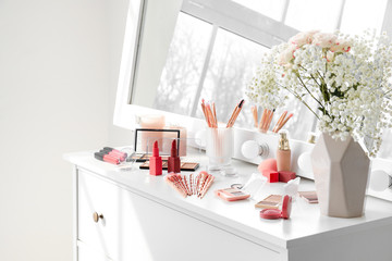 Set of decorative cosmetics on table of makeup artist in room