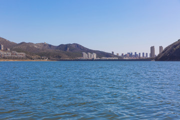 Fototapeta premium Winter outdoor dam and city of Xishan Lake in Dalian, China