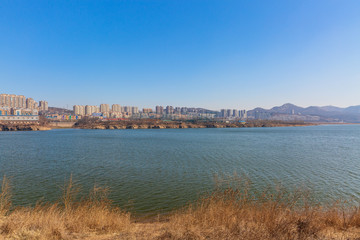Winter outdoor dam and city of Xishan Lake in Dalian, China