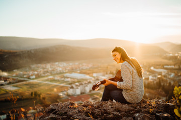 Young guitarist playing acoustic guitar and looking to sunset.Searching inspiration.Music...