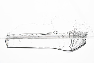 the fork falls into the water creating splashes