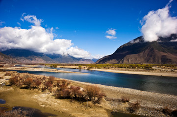 mountain and river landscape with blue sky and clouds, Tibet, China 