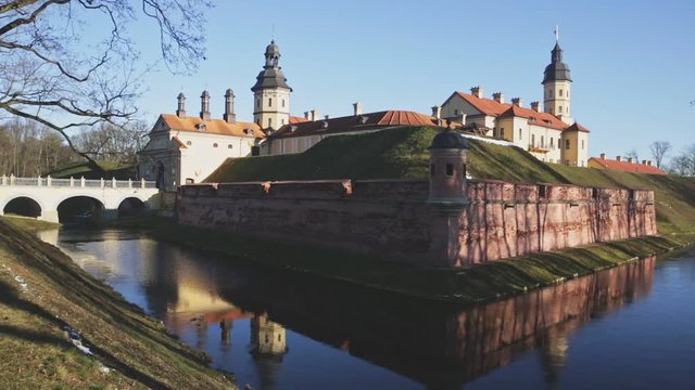 Scenic winter landscape with architectural and cultural complex of Nesvizh Castle on sunny day, Minsk region, Belarus
