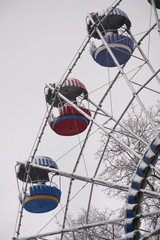 Ferris wheel in a snow-covered city Park