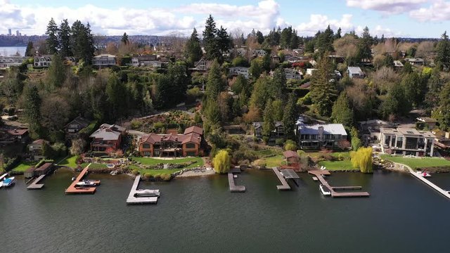 Aerial / drone footage of Meydenbauer Bay, beach park, marinas with waterfront mansions in Belleview near Seattle, Washington during the COVID-19 pandemic