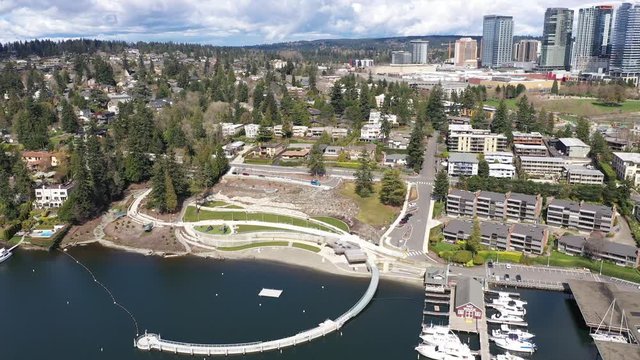 Aerial / drone footage of Meydenbauer Bay Park, empty beach park, marinas with waterfront mansions in Belleview near Seattle, Washington during the COVID-19 pandemic