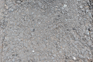 Texture of asphalt surface and crushed stone. Background asphalt road with crushed stone