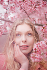 Fototapeta premium Girl in a cherry blossom garden