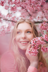 Obraz na płótnie Canvas Girl in a cherry blossom garden