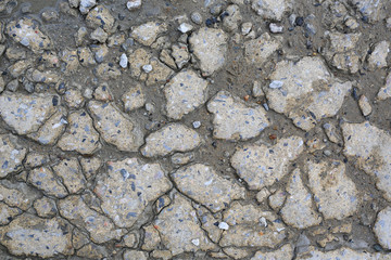 Cracked concrete road texture background. Close up top view.