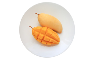 Naklejka na ściany i meble Golden mango fruit in white plate isolated on white background. Ripe yellow Barracuda mangos. Tropical fruit in thailand. Top view.