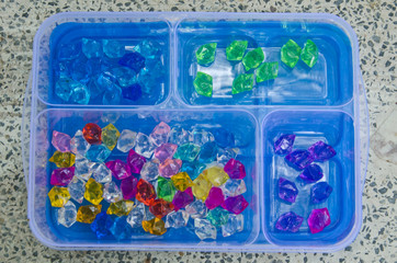 Top view of plastic box of beautiful jewels