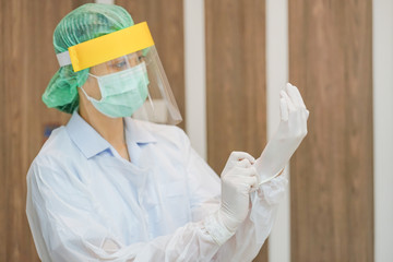 Front-line healthcare workers prepare wearing Personal Protective Equipment (PPE) for protect...