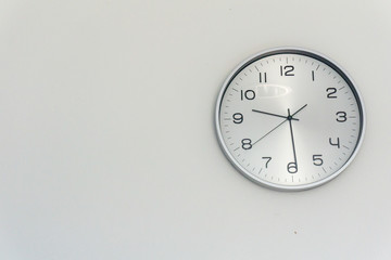 A wall clock with a white background