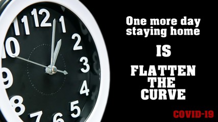 Clock dial close-up with COVID-19 pandemic quote: One more day staying home is flatten the curve. Table business timer face slogan. Quarantine time and self isolation Coronavirus concept.