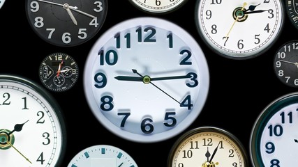 Multiply time clock faces appear showing different  time. Various clocks in busy time flow. Business or New Year Resolution concept. 