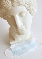 
Women with protective mask. Female statue with a protective mask.Social distance learning....