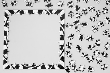 Naklejka premium Black and White Puzzle on Table from Above with Frame Completed