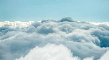 Above the clouds. View of Cumulus clouds from above. Blue sky above clouds