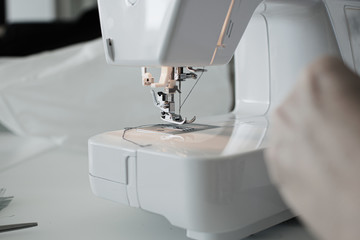 white sewing machine at work