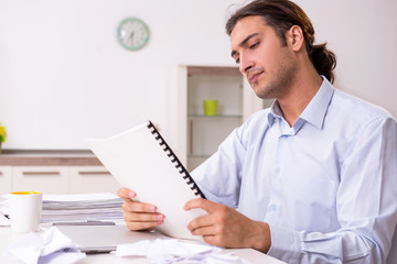 Young male businessman working at home