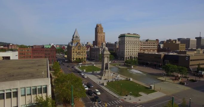 Syracuse, New York - 4K Aerial approach past monument and Clinton Square.