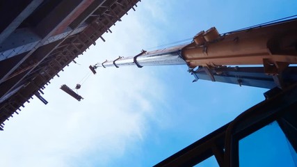 Telescopic arm of a mobile crane on building construction site - Powered by Adobe