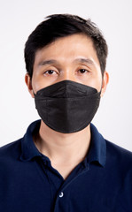 Young asian man wearing black hygienic mask to prevent infection, airborne respiratory illness as flu, 2019-nCoV COVID-19. Protection against contagious disease coronavirus pandemic white background.