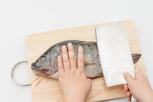 Tilapia is a eviscerated fish with a knife.