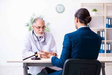 Male doctor in courthouse meeting with lawyer