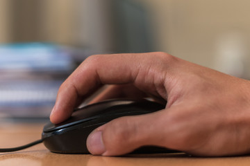 closeup of a person's hand using a computer mouse