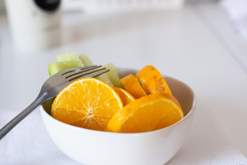 Close up of delicious fresh orange slices in a white bowl