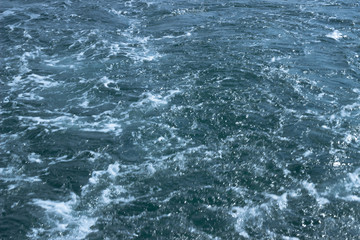 Fototapeta na wymiar A shot of chaotic water behind ship