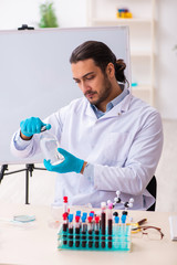 Young male chemist working in the lab